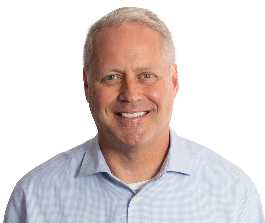 An image of Scott Huntsman, who is wearing a blue button down shirt, smiling at the camera.