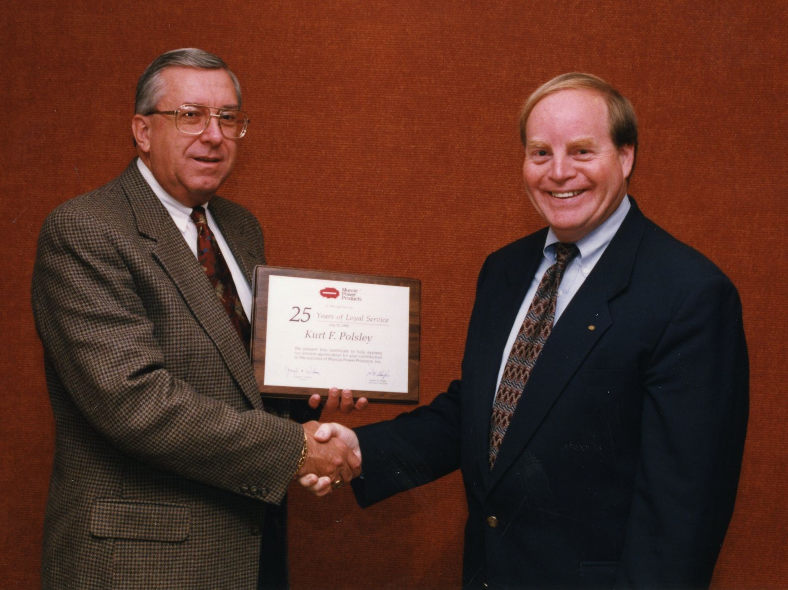 An archival photo of Kurt Polsley receiving his 25th anniversary plaque in 1996.