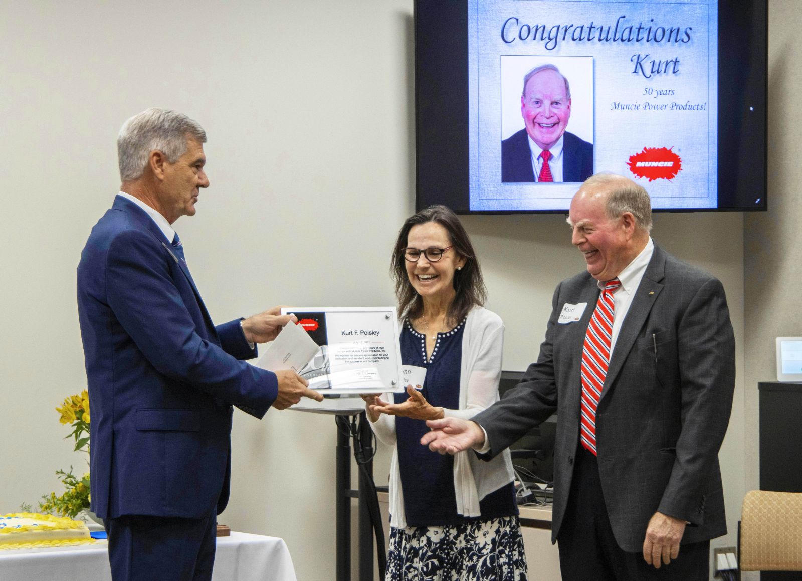 Kurt Polsley and his wife, Lynn, receiving their 50th anniversary plaque from Ray Chambers in 2021.