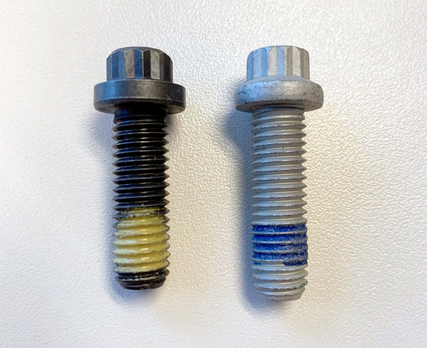 An image of two Muncie Power capscrews with factory-applied patch.