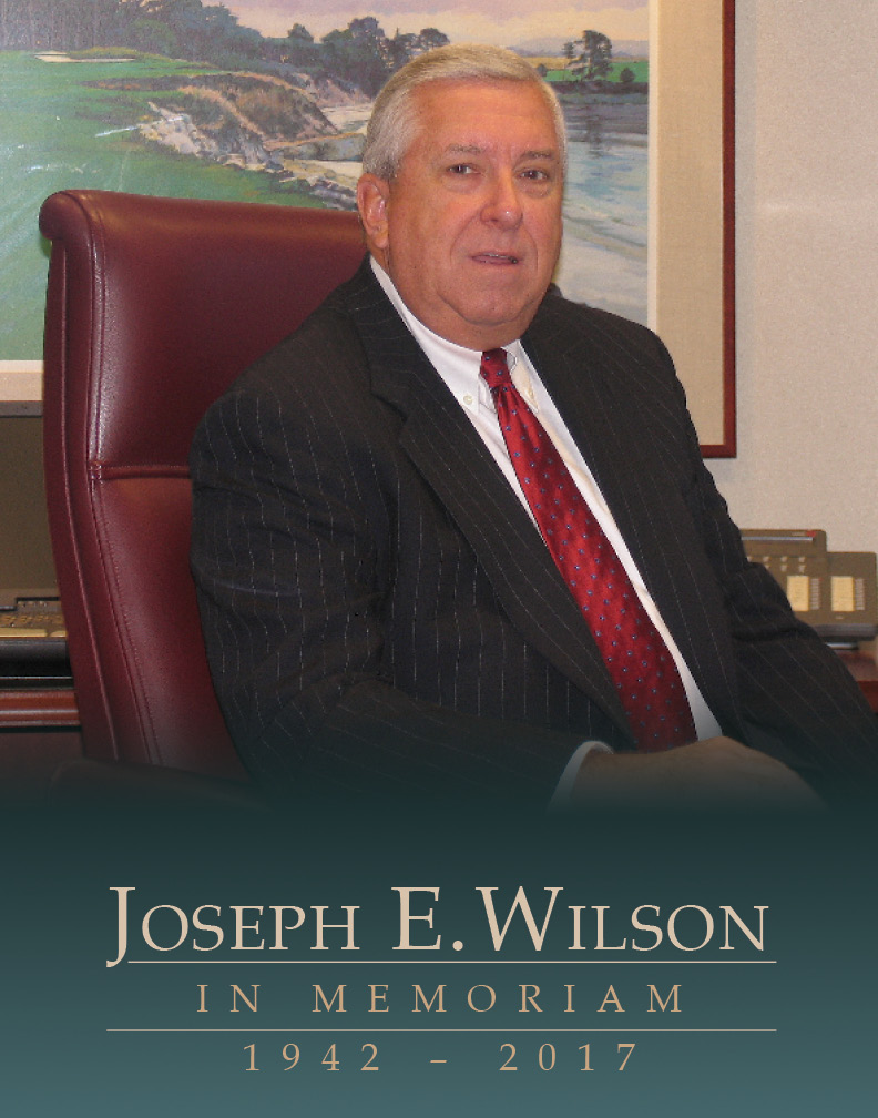 An image showing Joe Wilson sitting in a chair in a suit.