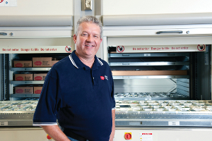 An image of Joe Huff standing in front of the lean-lifts in the Pershing Facility.