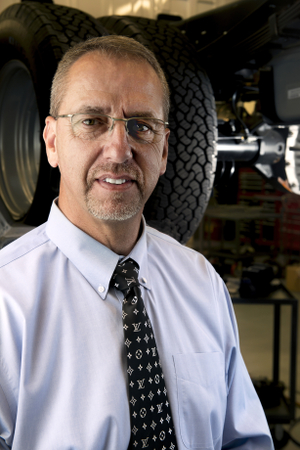 An image of Quality Manager Dale Wilson under a truck.