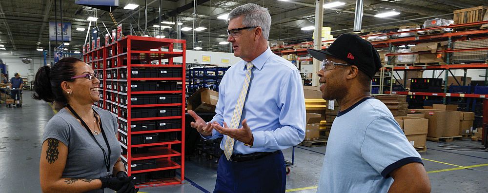 Chairman, CEO and President Ray Chambers talks with employees at the Tulsa division of Muncie Power Products