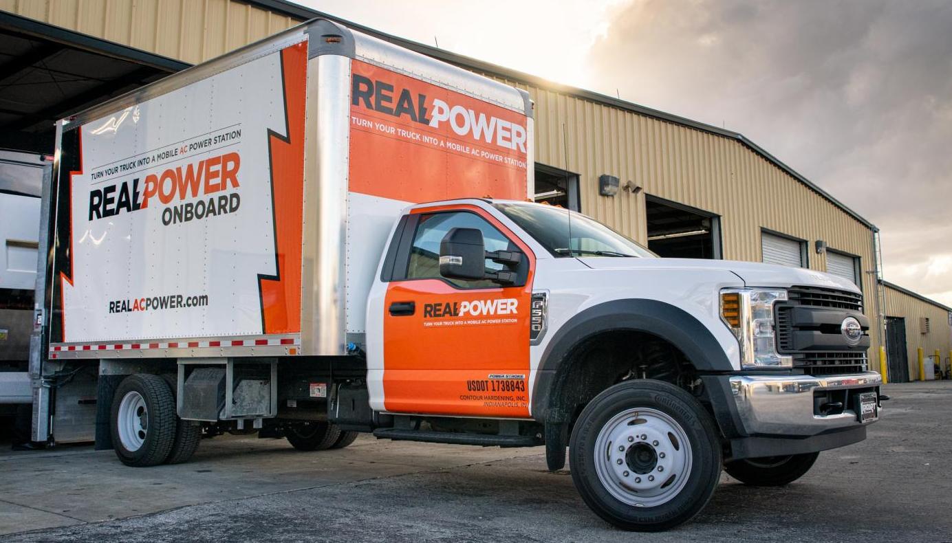 An image of a Real Power truck in front of a garage