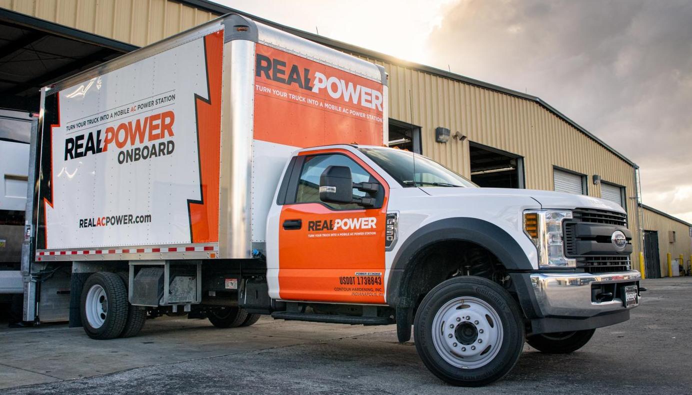 Real Power truck in front of a garage