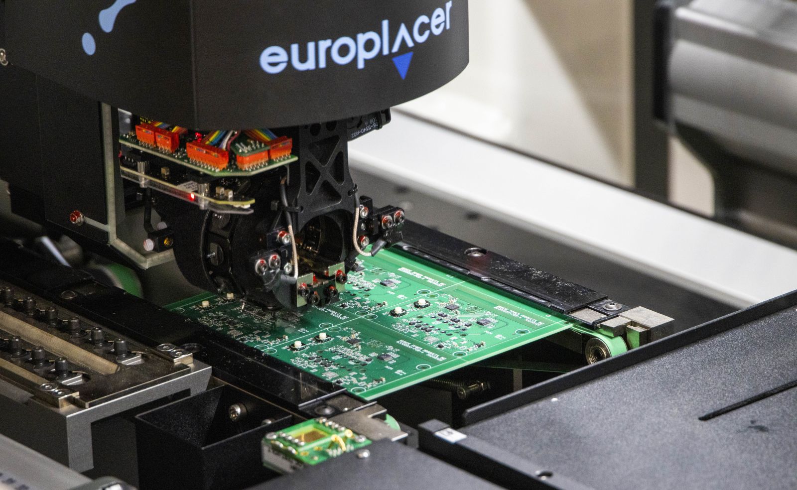 An image of the pick-and-place machine that places raw electrical components to the circuit board.