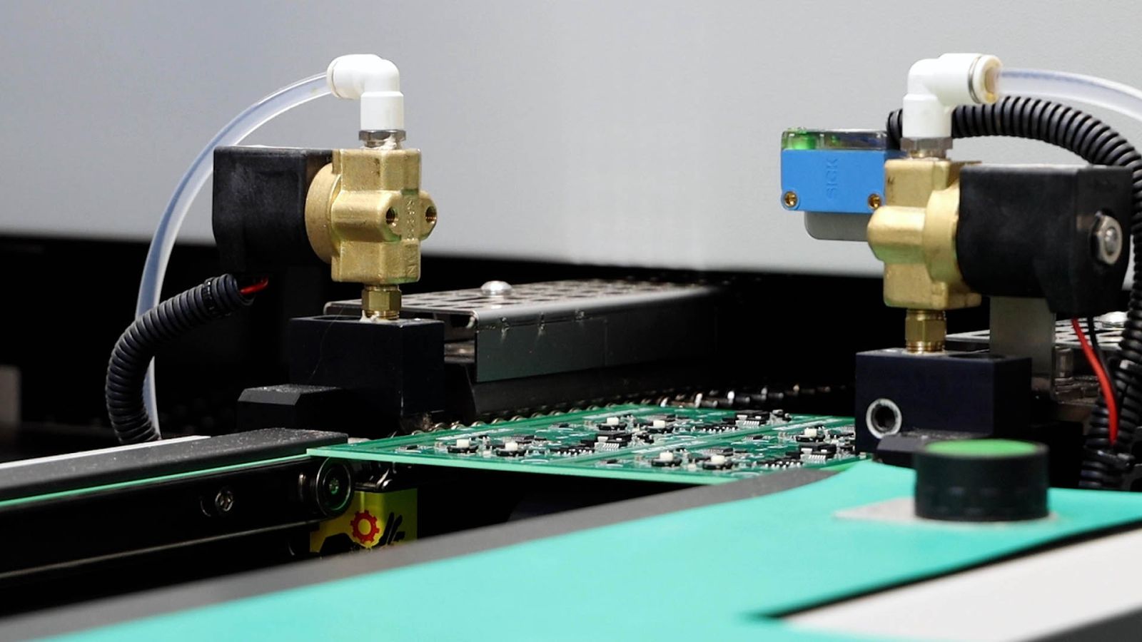 An image of a circuit board going into the reflow oven.